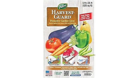 The image shows a lush, green lawn with various types of protective covers for new grass seed.