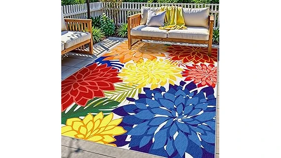 The image shows an attractive outdoor carpet laid on a concrete patio, perfect for outdoor living.