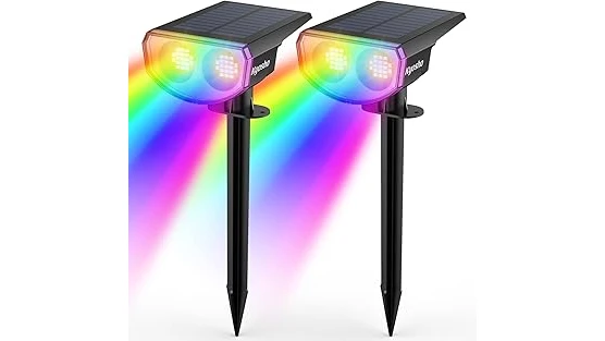 The image shows several solar spotlight fixtures illuminating a tree at night for a blog post.