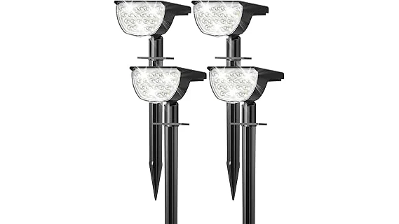 The image shows a backyard tree illuminated by several bright, strategically placed solar spotlights.