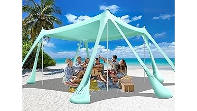 The image shows a sturdy beach canopy holding its ground against a strong ocean breeze.