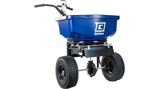 The image shows a durable commercial walk-behind salt spreader ready for winter application.