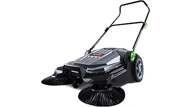 The image shows a person operating a powerful walk-behind leaf blower clearing a yard of autumn leaves.