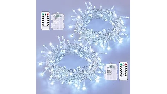 The image shows a festive string of battery powered Christmas lights illuminating a decorated tree branch.